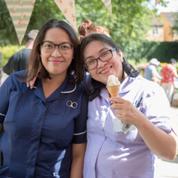 QH carousel image showing members of staff enjoying an ice cream
