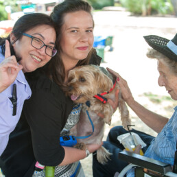 QH carousel image displaying staff holding a small dog allowing residents to be close